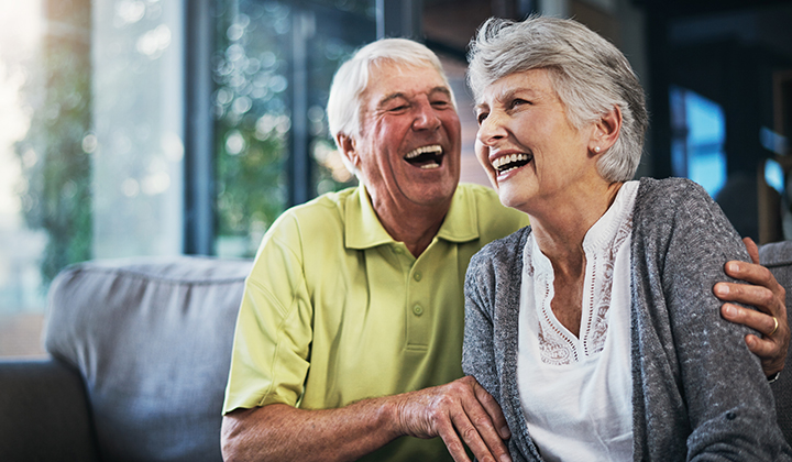 Older couple laughing.