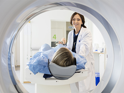 Doctor with patient getting CT scan.