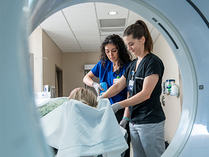 Prepping patient for CT scan.