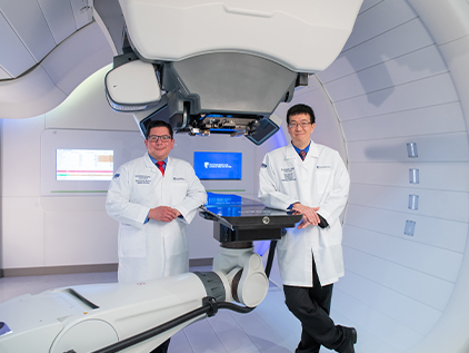 Dr. Rotondo and Dr. Chin standing in the Proton Therapy vault