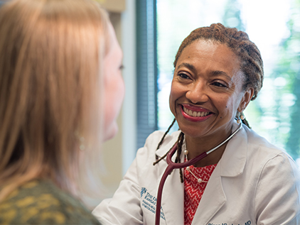 Dr. Khabele visiting with patient.