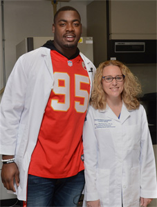 Grant-winning researcher Mary Markiewicz, Ph.D, and Kansas City Chiefs' player Chris Jones.