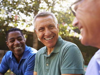 Three men laughing outside