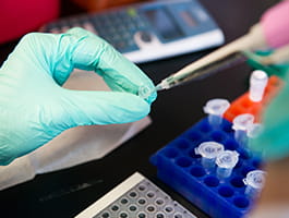Researcher using syringe.