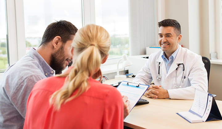 Couple meeting with doctor.