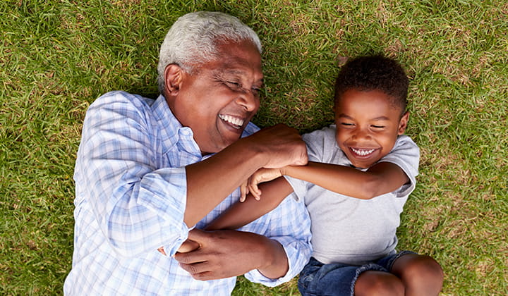 Grandpa laughing with grandson.