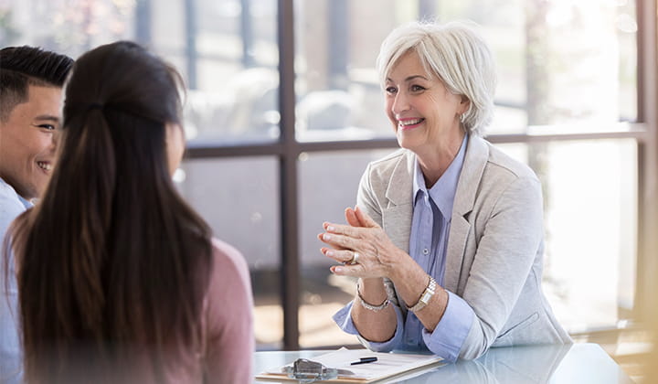 Woman meeting with couple.
