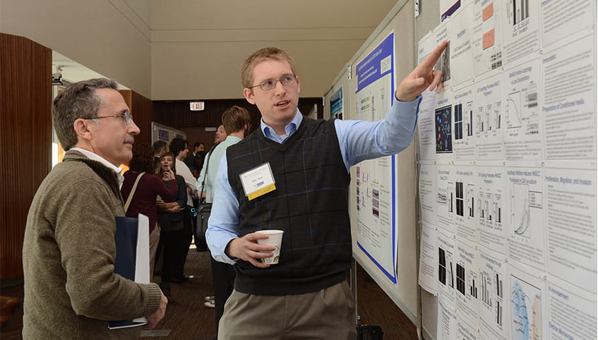 Cancer center members at a symposium.