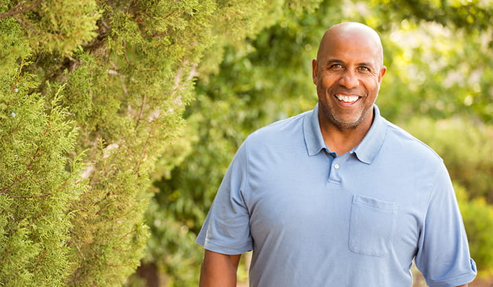 Mature man smiling outside
