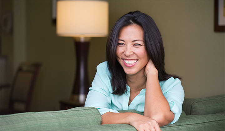 Happy woman smiling on couch