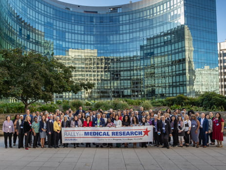 Group of individuals stands together holding a Rally for Medical Research sign in Washington DC