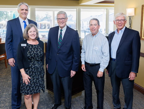 Group of individuals at community event smiling