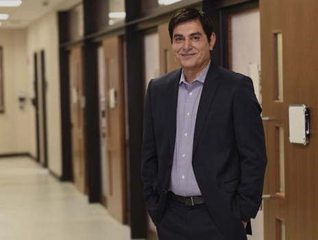 Man in a dark suit jacket in hallway