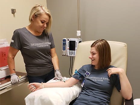 Cancer center employee giving blood.