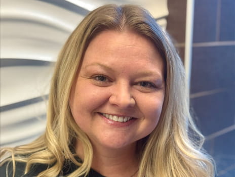 Woman with long blond hair smiling