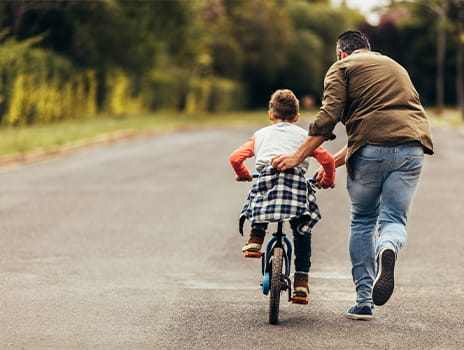Dad and son riding bike