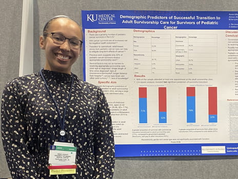 Renee Gilbert stands in front of a scientific poster at a conference