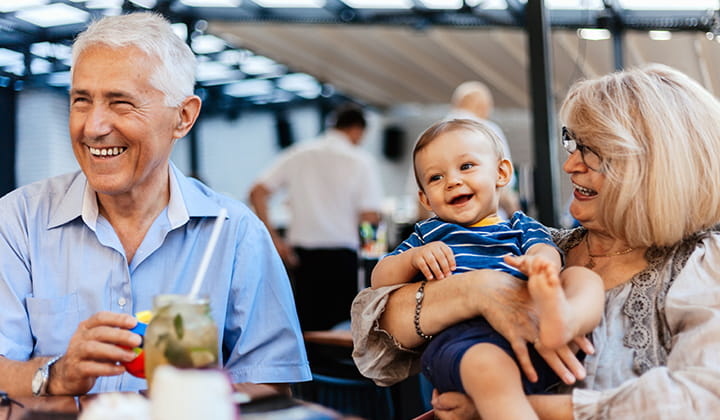 Happy grandparents after recovering from liver cancer treatment.