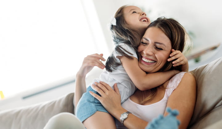 Mother and daughter laughing.